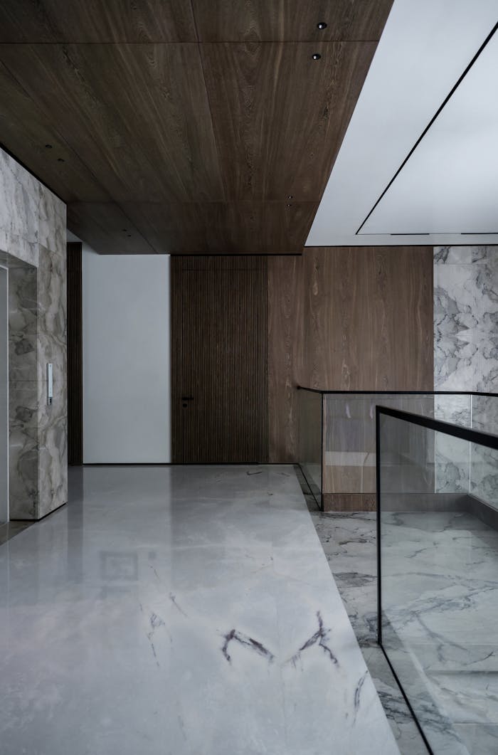 Luxurious modern interior featuring marble floors and wood paneling for a sleek design.